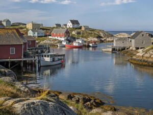 Colorful Atlantic coast fishing village with wooden houses beside the water in Canada