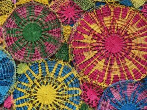Close-up of colorful handmade nanduti lace in circular spiderweb patterns in Paraguay